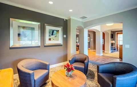 a living room with chairs and a table